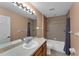Well-lit bathroom with modern vanity, a bathtub, and tile flooring creating a clean design at 2857 Brewster Rd, North Port, FL 34288