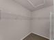 Walk-in closet features built-in shelving for ample storage and organization at 2857 Brewster Rd, North Port, FL 34288