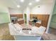 The kitchen features a spacious island, tile floors, stainless steel appliances and light-colored cabinets at 2857 Brewster Rd, North Port, FL 34288
