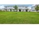 Large grassy backyard with covered patios, ideal for outdoor relaxation and entertaining at 31895 Anchor Point Dr, Wesley Chapel, FL 33545