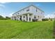 Townhome backyard featuring lush green grass and views of the covered patio areas at 31895 Anchor Point Dr, Wesley Chapel, FL 33545