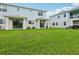Manicured backyard with healthy green grass and covered patio areas offering excellent views at 31895 Anchor Point Dr, Wesley Chapel, FL 33545