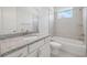 Bright bathroom featuring granite counters, a shower-tub combo, and tile floors at 31895 Anchor Point Dr, Wesley Chapel, FL 33545