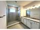 Modern bathroom features a glass enclosed shower and double sink vanity with granite countertops at 31895 Anchor Point Dr, Wesley Chapel, FL 33545