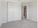 Bedroom showcasing a sliding door closet and doorway to the hallway at 31895 Anchor Point Dr, Wesley Chapel, FL 33545