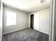 Bedroom with neutral carpet, base trim, closet and a bright window for natural light at 31895 Anchor Point Dr, Wesley Chapel, FL 33545