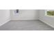 Sunlit bedroom with new gray carpet and large windows at 31895 Anchor Point Dr, Wesley Chapel, FL 33545