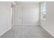 Bright bedroom featuring gray carpet, a window, and a doorway at 31895 Anchor Point Dr, Wesley Chapel, FL 33545