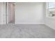 Bright bedroom featuring soft gray carpet, neutral walls, and a window offering natural light at 31895 Anchor Point Dr, Wesley Chapel, FL 33545