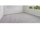 Bright bedroom with gray carpet, trim, and two large windows at 31895 Anchor Point Dr, Wesley Chapel, FL 33545