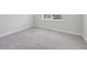Brightly lit bedroom featuring new gray carpet with white trim at 31895 Anchor Point Dr, Wesley Chapel, FL 33545