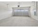 Spacious garage with a concrete floor, garage door opener, and an electrical panel at 31895 Anchor Point Dr, Wesley Chapel, FL 33545