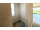Bright hallway leading to the living area with a view of the backyard through sliding glass doors at 31895 Anchor Point Dr, Wesley Chapel, FL 33545