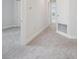 Hallway with carpeted floors leading to a bright room, showing clean lines and neutral colors at 31895 Anchor Point Dr, Wesley Chapel, FL 33545