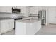 Bright kitchen featuring stainless steel appliances, granite countertops, and white cabinets at 31895 Anchor Point Dr, Wesley Chapel, FL 33545