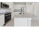 Bright kitchen featuring stainless steel appliances, granite countertops, and white cabinets at 31895 Anchor Point Dr, Wesley Chapel, FL 33545