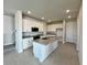 Modern kitchen with white cabinets, stainless steel appliances, and granite countertops at 31895 Anchor Point Dr, Wesley Chapel, FL 33545
