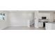 A bright kitchen and stairway with sleek white cabinets and granite countertops create a modern, clean design at 31895 Anchor Point Dr, Wesley Chapel, FL 33545