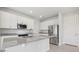 Modern kitchen featuring stainless steel appliances and a large island with granite countertops at 31895 Anchor Point Dr, Wesley Chapel, FL 33545
