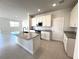 A well-lit kitchen boasts white cabinets, granite countertops, and stainless steel appliances at 31895 Anchor Point Dr, Wesley Chapel, FL 33545