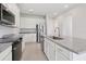 Modern kitchen featuring stainless steel appliances, white cabinets, and granite countertops at 31895 Anchor Point Dr, Wesley Chapel, FL 33545