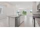 Open kitchen with granite countertops, stainless steel appliances, and views of the backyard through sliding glass doors at 31895 Anchor Point Dr, Wesley Chapel, FL 33545