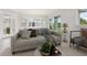 This is a virtually staged living room with sofa, table and chairs near the sliding glass doors at 31895 Anchor Point Dr, Wesley Chapel, FL 33545