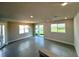 Expansive living room with tile flooring, large windows, and sliding door access to the outdoors at 31895 Anchor Point Dr, Wesley Chapel, FL 33545