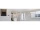 Bright open-concept living room with stairs to the second floor and open view to the kitchen at 31895 Anchor Point Dr, Wesley Chapel, FL 33545