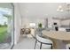 Bright, open-concept living room and kitchen featuring modern decor and lots of natural light at 31895 Anchor Point Dr, Wesley Chapel, FL 33545