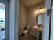 Half bathroom showcasing modern fixtures, including a pedestal sink and a toilet at 31901 Anchor Point Dr, Wesley Chapel, FL 33545