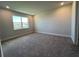 This bedroom offers neutral walls, plush carpeting, and a large window for ample natural light at 31901 Anchor Point Dr, Wesley Chapel, FL 33545