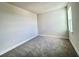 This bedroom features neutral walls, plush carpeting, and a bright window for natural light at 31901 Anchor Point Dr, Wesley Chapel, FL 33545