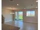 Open-concept living space with tile floors, recessed lighting, and sliding doors to the backyard at 31901 Anchor Point Dr, Wesley Chapel, FL 33545