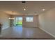 Spacious living room featuring tile floors, recessed lights, and sliding glass doors at 31901 Anchor Point Dr, Wesley Chapel, FL 33545