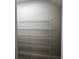 View of a pantry with multiple shelves and a gray tiled floor at 31901 Anchor Point Dr, Wesley Chapel, FL 33545
