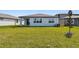 Expansive backyard of this home with lush green grass and views of the home's exterior at 6741 Michael Favor Way, Wesley Chapel, FL 33545