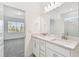 Bright bathroom featuring double vanity sinks, modern fixtures, and ample counter space at 6741 Michael Favor Way, Wesley Chapel, FL 33545