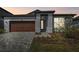 Charming single-story home featuring a two-car garage and well-manicured landscaping at 6741 Michael Favor Way, Wesley Chapel, FL 33545