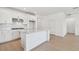 Open kitchen with a center island, ample white cabinetry, and stainless steel appliances at 6741 Michael Favor Way, Wesley Chapel, FL 33545