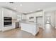 Bright kitchen boasts white cabinets, stainless steel appliances, and an island with a stone countertop at 6741 Michael Favor Way, Wesley Chapel, FL 33545