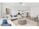 Bright, open-concept living room and kitchen area with modern design and stainless steel appliances at 6741 Michael Favor Way, Wesley Chapel, FL 33545
