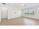 Bright room featuring a light wood floor, neutral walls and a large window at 6741 Michael Favor Way, Wesley Chapel, FL 33545