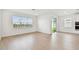 Bright living room with hardwood floors and a large window overlooking the backyard at 6741 Michael Favor Way, Wesley Chapel, FL 33545