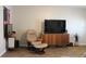 Relaxing living room with hardwood floors and large TV at 4460 95Th N Ave # 1, Pinellas Park, FL 33782