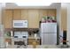 Cozy kitchen with light wood cabinets and white appliances at 4460 95Th N Ave # 1, Pinellas Park, FL 33782