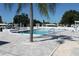 Community pool with palm trees and patio area at 4460 95Th N Ave # 1, Pinellas Park, FL 33782