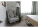 Bedroom with a plaid chair and large window at 4460 95Th N Ave # 1, Pinellas Park, FL 33782