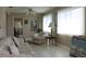 Cozy living room with tiled floor, sofa, armchair, and large windows at 4460 95Th N Ave # 1, Pinellas Park, FL 33782