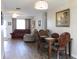 Bright dining room with wood table and chairs, hardwood floors, and view to living room at 4460 95Th N Ave # 1, Pinellas Park, FL 33782